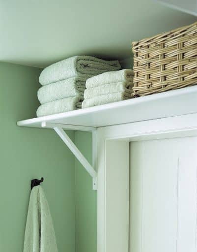 A shelf above the bathroom door provides added storage.