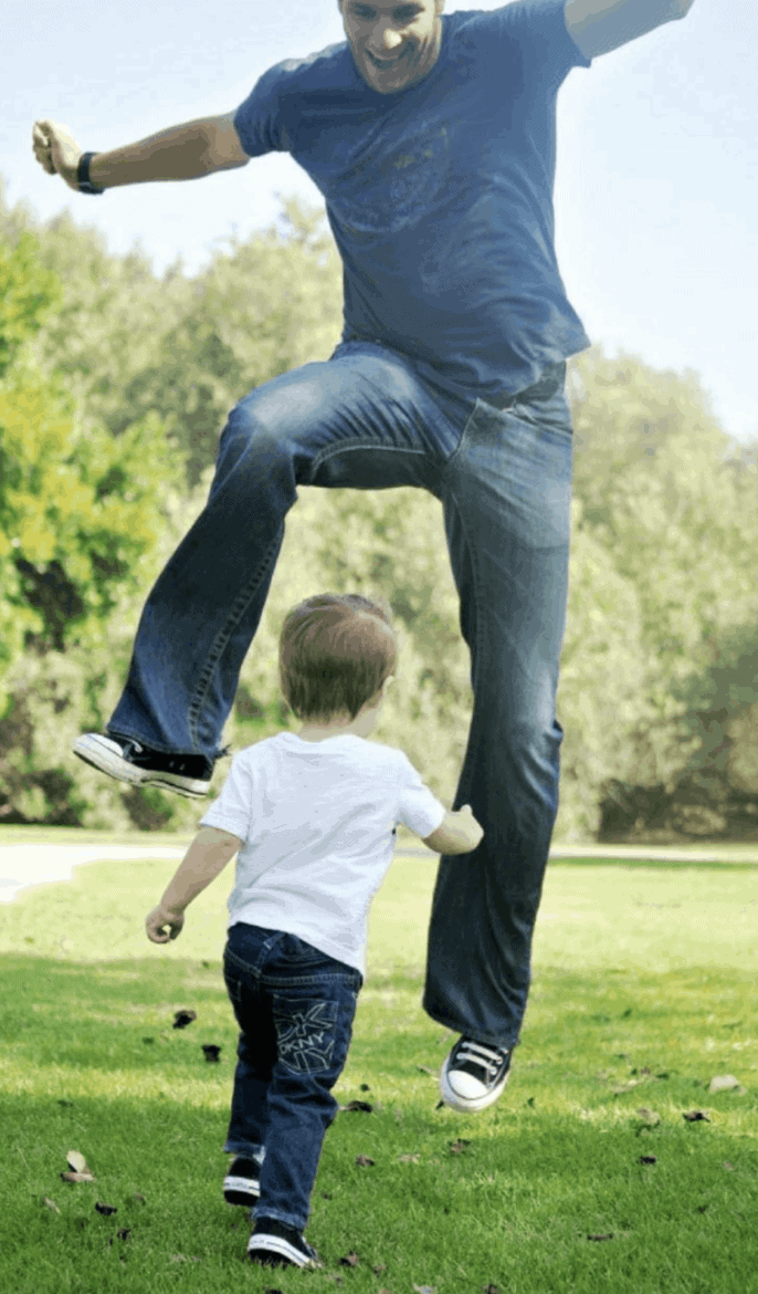 father jumping over son