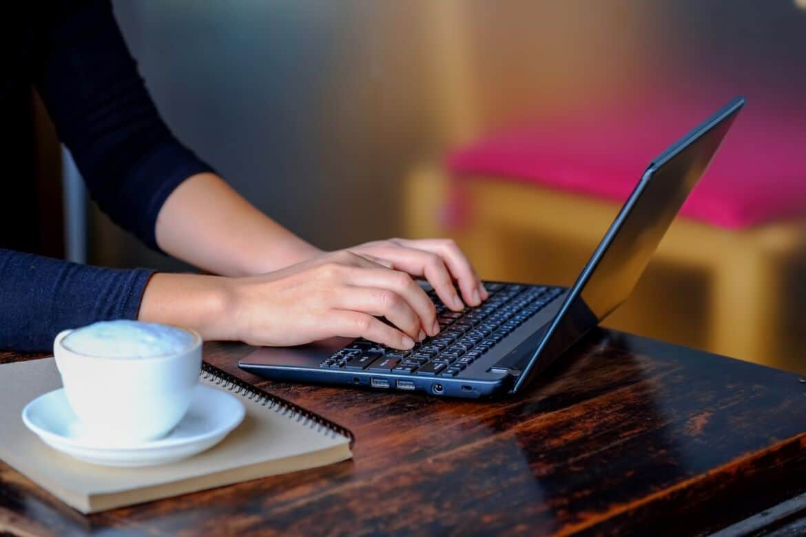 woman-working-using-laptop-computer-with-coffee-PRSE6LY
