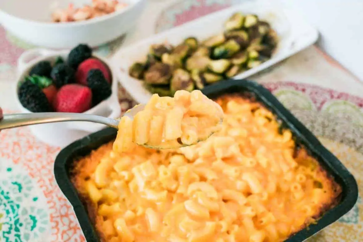spoonful of mac and cheese above a serving dish for an Easy Weekday Dinner