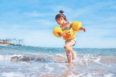 girl water beach playing splash