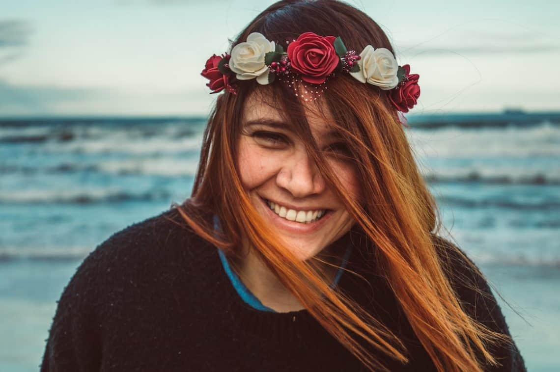 laughing woman flowers hair