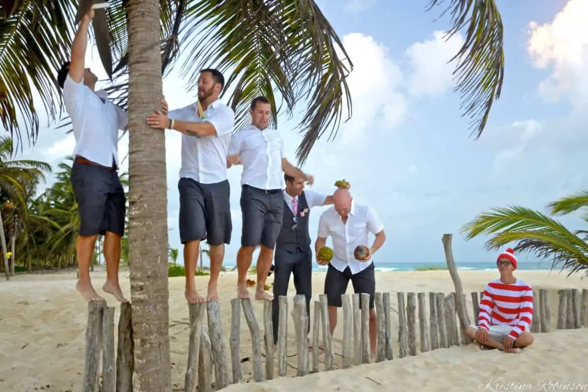 fun bridal party photo groomsmen playing with coconuts