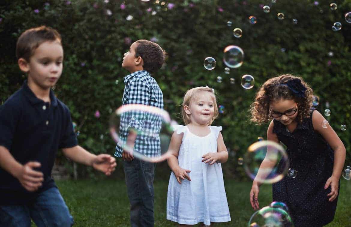 chilldren playing with bubbles