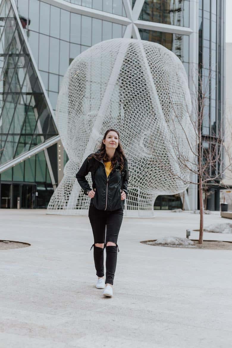 girl walking in front of buildings