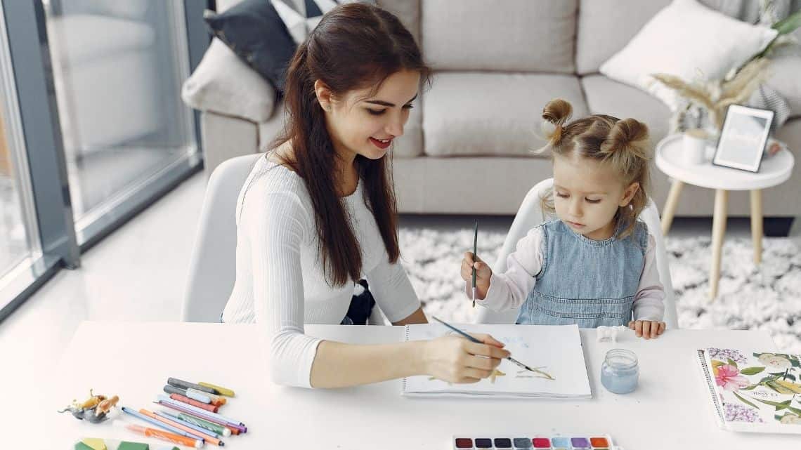 woman painting with young child