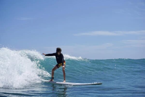 boy surfing in waikiki