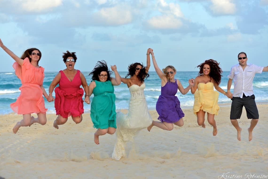 bride jumps with bridesmaids